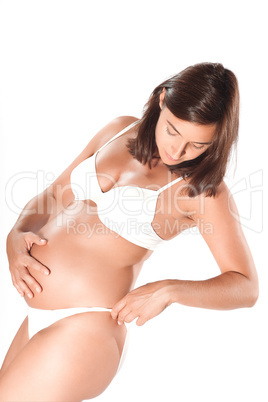 Pregnant woman examining her hips