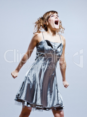 beautiful young girl with prom dress screaming anger
