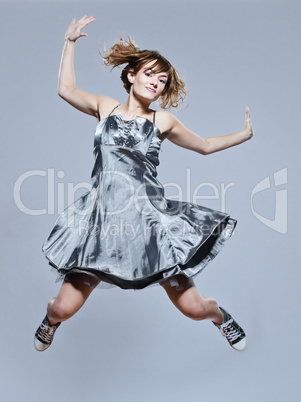 beautiful young girl with prom dress jumping happy