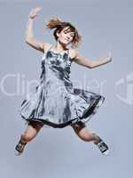 beautiful young girl with prom dress jumping happy