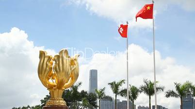 Statue of the Golden Bauhinia with China and Hong Kong flags flying