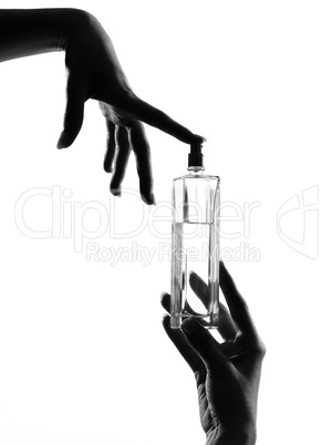 detail close-up silhouette woman hands with perfume