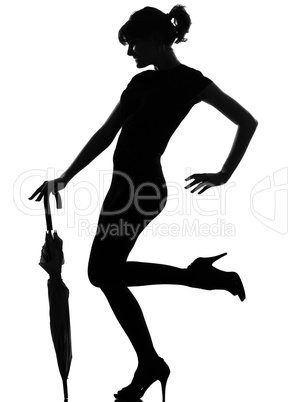 silhouette woman holding closed umbrella