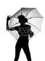 silhouette woman holding open umbrella