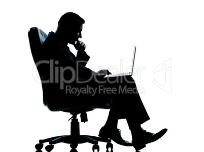 one business man computer computing sitting in armchair silhouet