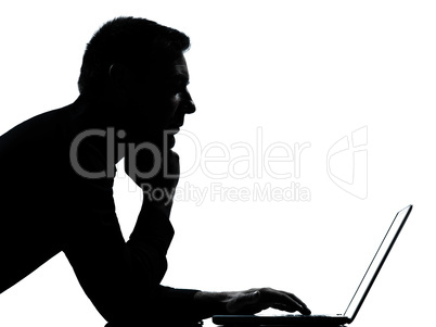 one business man silhouette computing computer laptop serious
