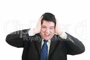 Frustrated young businessman pulling his hair, studio shot