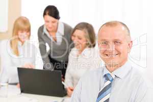 Smiling businessman during team meeting