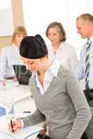 Young executive woman take notes during meeting