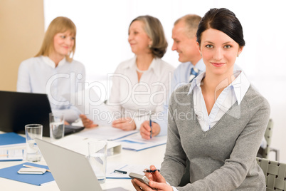 Young executive woman use phone during meeting