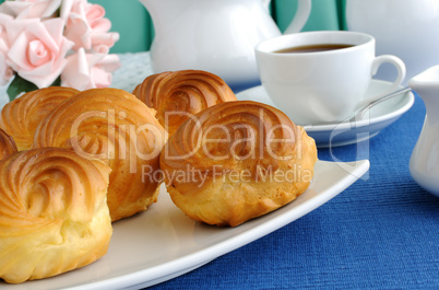 Eclairs with a cup of coffee