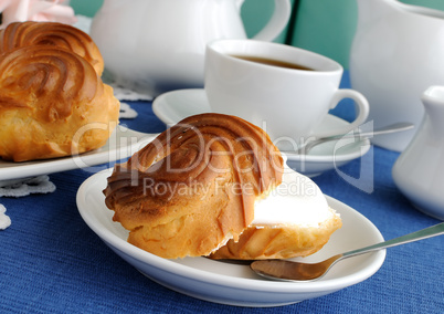 Eclairs with a cup of coffee