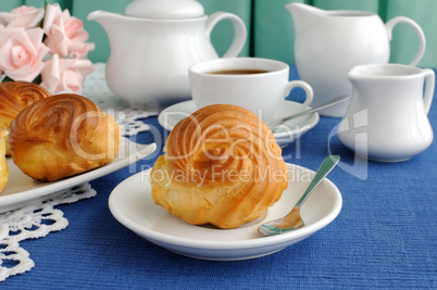 Eclairs with a cup of coffee