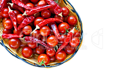 Basket of ripe cherry tomatoes and red chillies