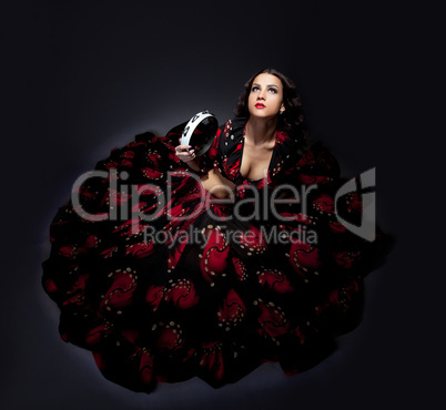 young woman posing in flamenco costume isolated