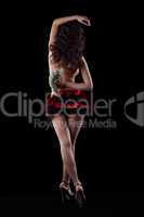 Striptease girl in red dance with money in dark