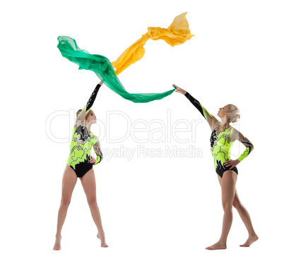 Two beauty gymnasts dance with flying fabric