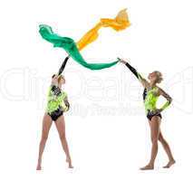 Two beauty gymnasts dance with flying fabric