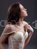Young sensuality woman posing in white lingerie