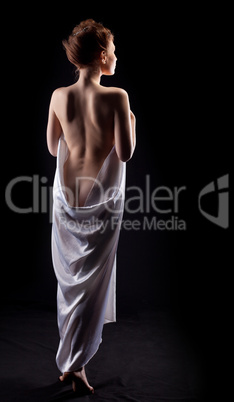 Beauty nude woman posing like statue in dark