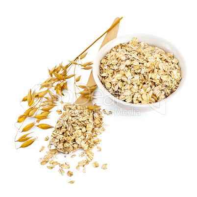 Rolled oats in a bowl and spoon