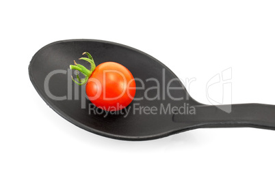 Tomato on a black spoon