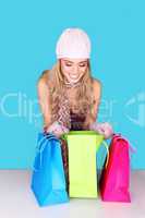 Excited Woman Looking In Shopping Bag