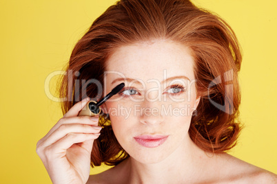 Glamorous Redhead Applying Mascara