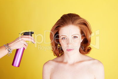 Hairstylist Applying Hair Spray