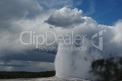 Old Faithful Geysir and clouds, Yellowstone, Wyoming