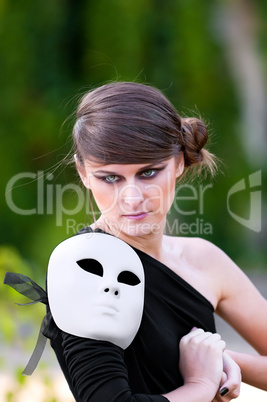 Caucasian girl with white mask on shoulder