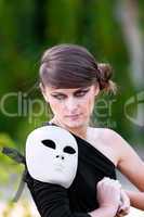 Caucasian girl with white mask on shoulder