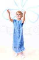 Cheerful little girl in knitted blue dress