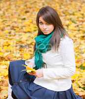 Beautiful woman with yellow leaf
