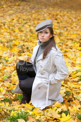 Beautiful woman in cap and white coat