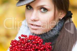 Beautiful woman portrait with viburnum berries