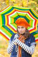 Young pretty girl with striped umbrella