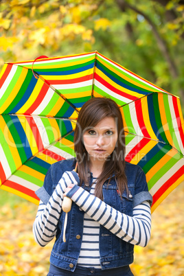 Young pretty girl with striped umbrella