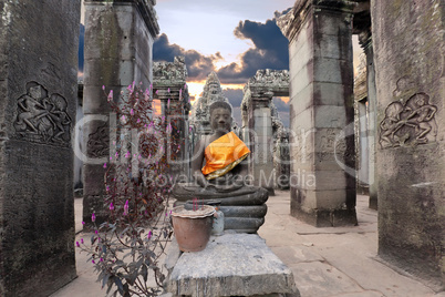 Buddha sitting in ancient temple Prasat Bayon