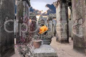 Buddha sitting in ancient temple Prasat Bayon