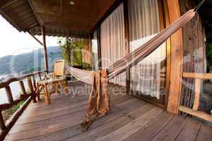 Hammock and chair on terrace of bungalow