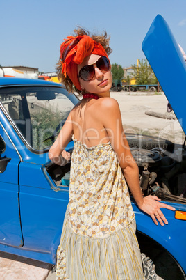 Vintage girl posing in front of the car