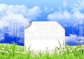 White sign with flowers and grass