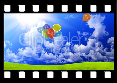 Filmstrip with color balloons in the dark blue sky