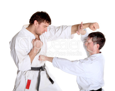 Karate. Men in a kimono with a white background.