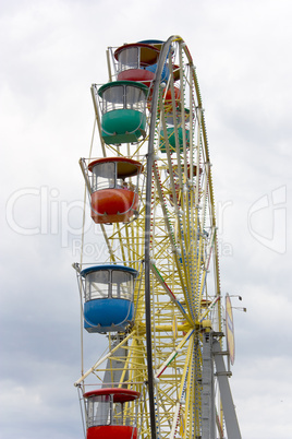 Ferris wheel against a background of clouds