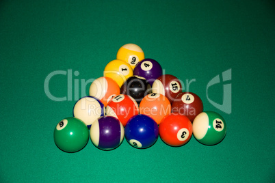 Billiard balls - pool, on a green table.