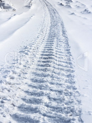 Traces from wheels of the  car on snow