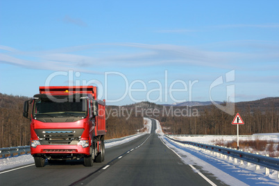 The red truck on a winter road.