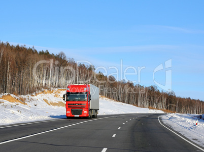 The red truck on a winter road.